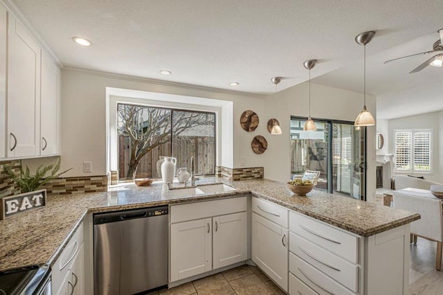 kitchen with white cabinetry, appliances with stainless steel finishes, sink, and kitchen peninsula