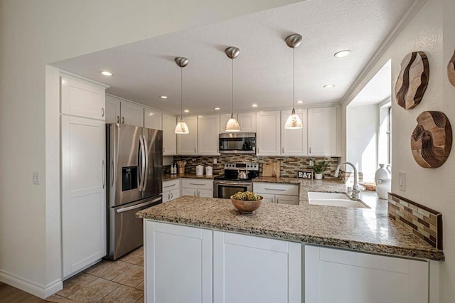 kitchen with sink, white cabinetry, hanging light fixtures, kitchen peninsula, and stainless steel appliances