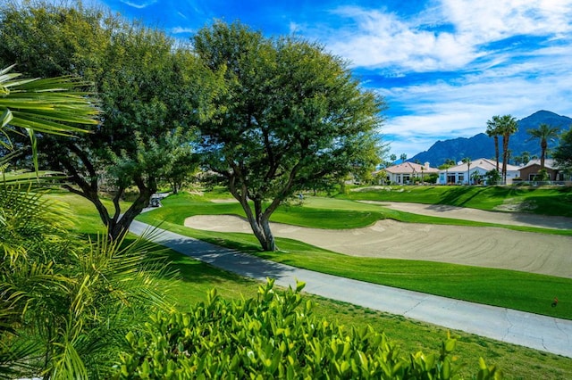 surrounding community featuring a mountain view and a lawn