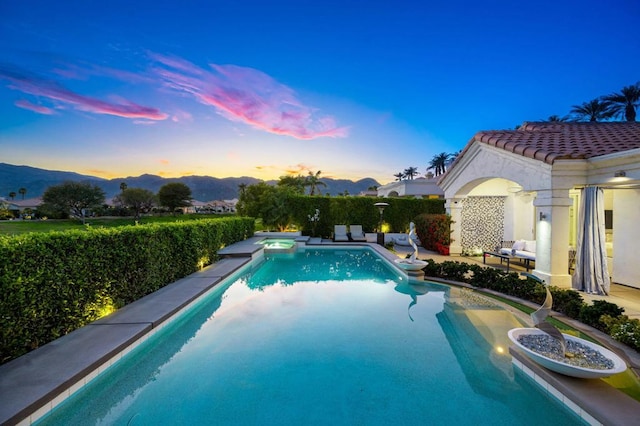 pool at dusk with a mountain view