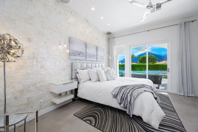 bedroom featuring access to exterior and concrete floors