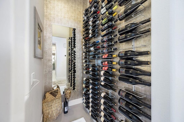 wine area featuring concrete flooring