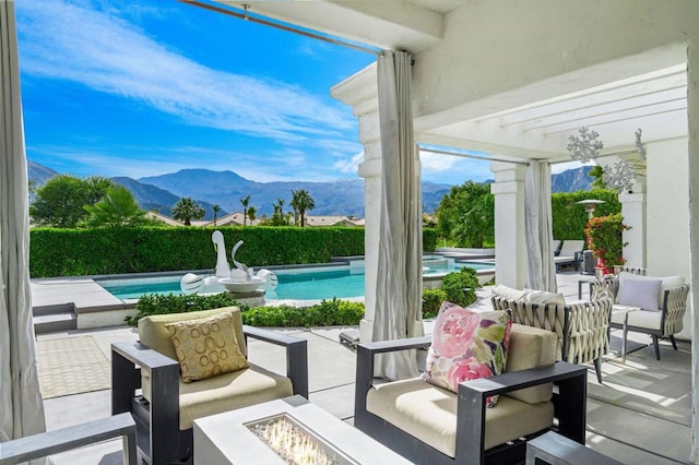 view of patio / terrace featuring a pergola, a fenced in pool, a fire pit, and a mountain view