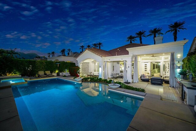 view of pool with an in ground hot tub, outdoor lounge area, ceiling fan, and a patio area