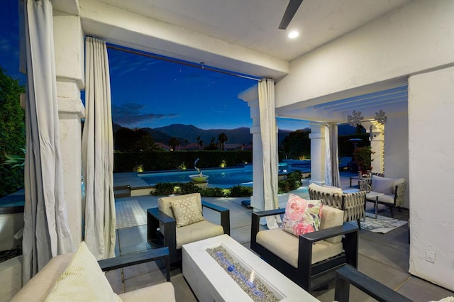 view of patio featuring an outdoor living space with a fire pit