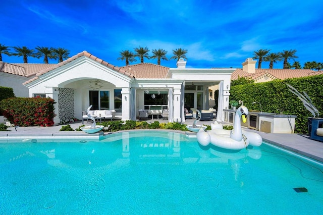 rear view of house featuring a patio, an outdoor hangout area, and ceiling fan