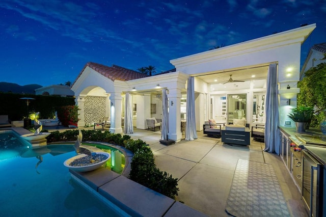 exterior space with an outdoor living space, a patio, and ceiling fan