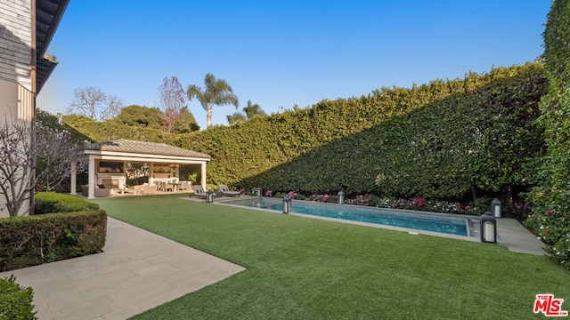 view of yard featuring a gazebo, outdoor lounge area, an outdoor structure, and a patio area