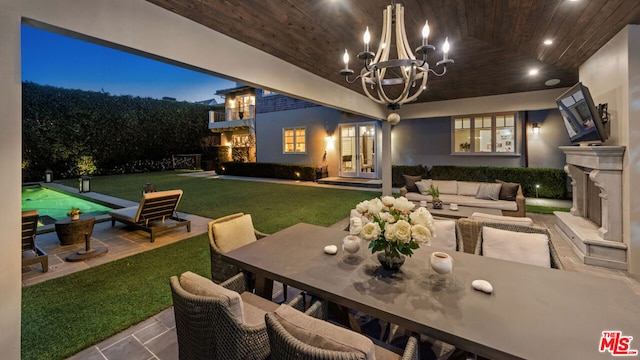 interior space with an outdoor hangout area, a lawn, and french doors