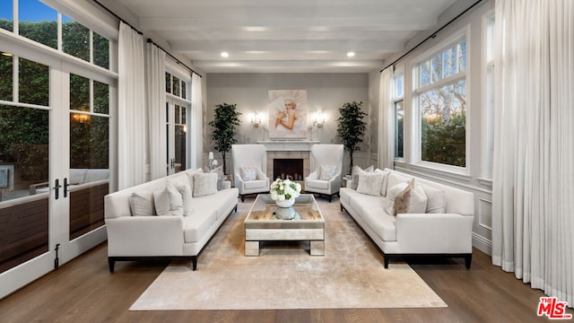 interior space featuring wood-type flooring, french doors, and beamed ceiling