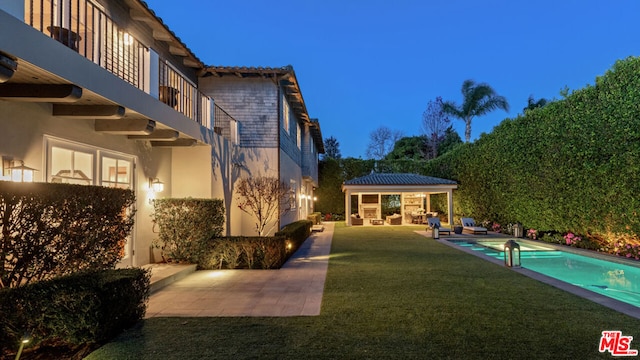 view of yard with an outdoor living space, a gazebo, a patio, and a balcony