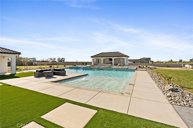 view of swimming pool featuring pool water feature, a patio area, a lawn, an outdoor structure, and an outdoor hangout area