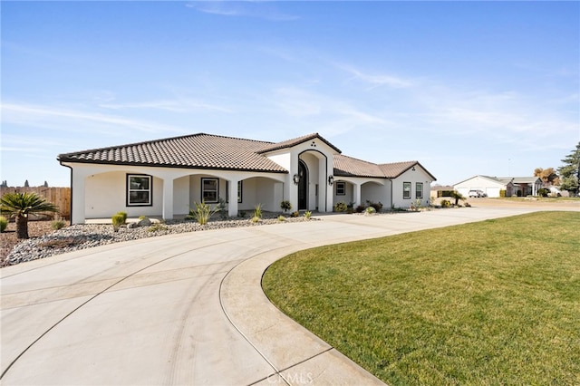 mediterranean / spanish house with a front lawn