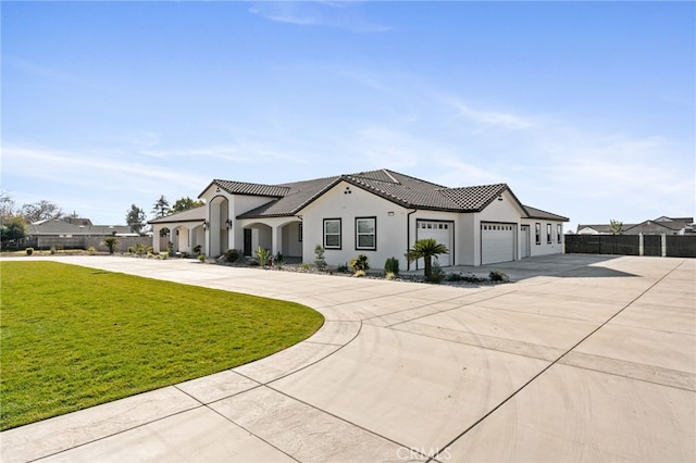 mediterranean / spanish-style home with a garage and a front yard