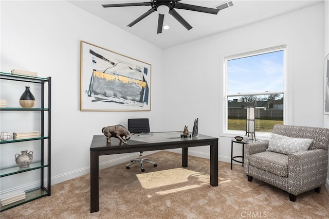 carpeted home office with ceiling fan