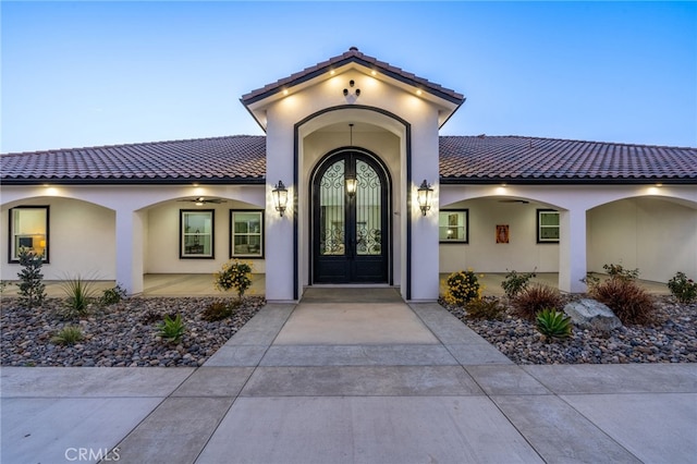 exterior entry at dusk featuring french doors