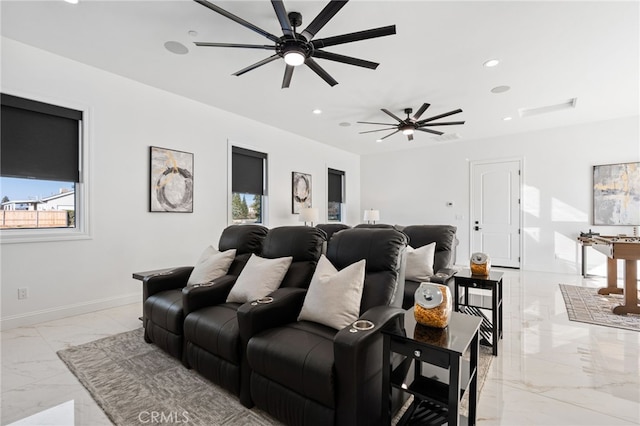 cinema room with ceiling fan and plenty of natural light