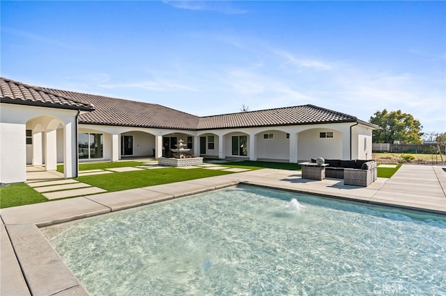 back of house featuring an outdoor living space and a patio area