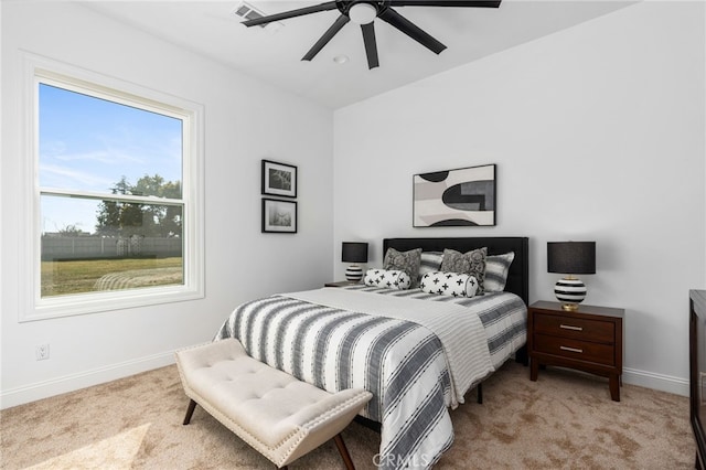 bedroom featuring light colored carpet and ceiling fan