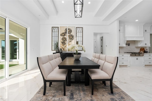 dining space featuring beam ceiling