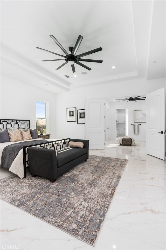 bedroom featuring ceiling fan and a tray ceiling