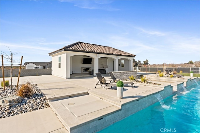 view of pool featuring pool water feature, ceiling fan, and a patio area