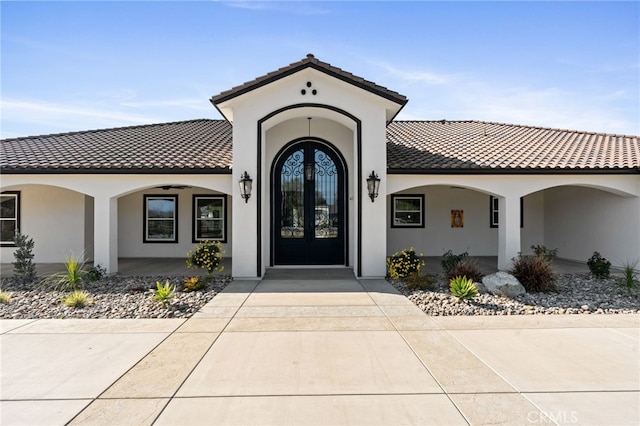 doorway to property with french doors and a porch