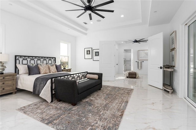 bedroom featuring ceiling fan and a tray ceiling