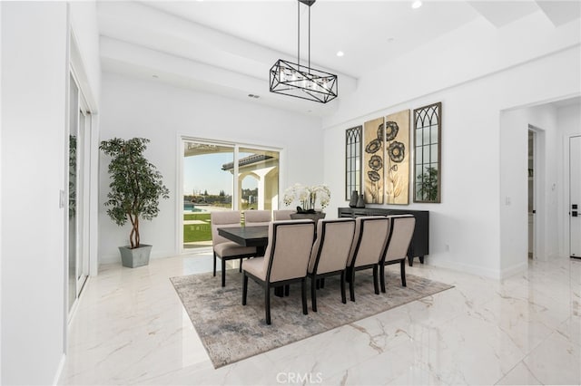 dining space with an inviting chandelier