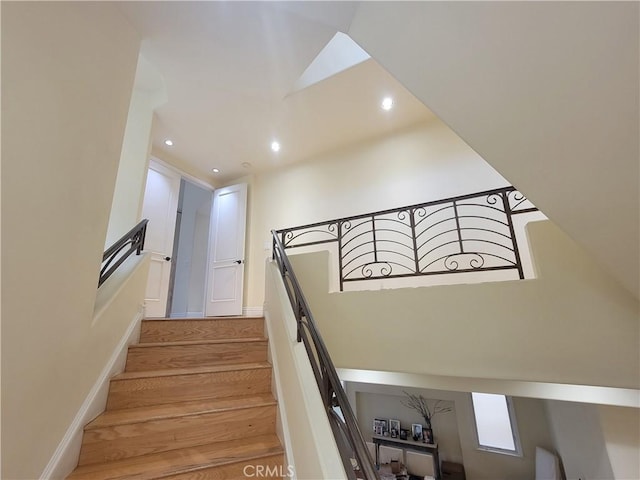 staircase with hardwood / wood-style floors