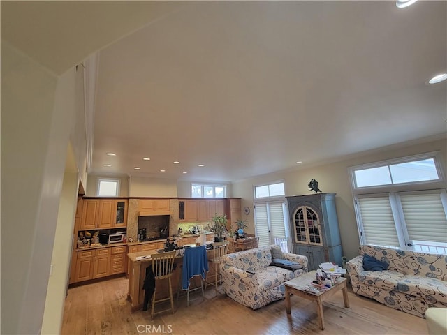 living room featuring light hardwood / wood-style flooring and ornamental molding