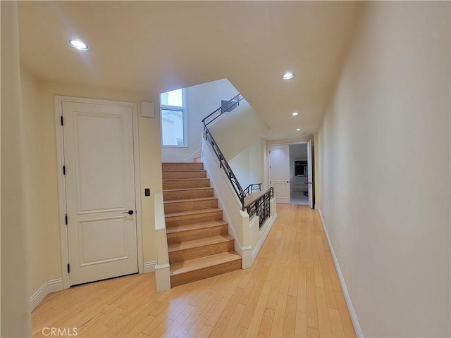 stairs with hardwood / wood-style floors