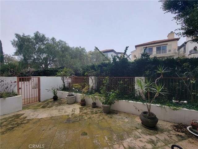 view of patio with a gate and fence