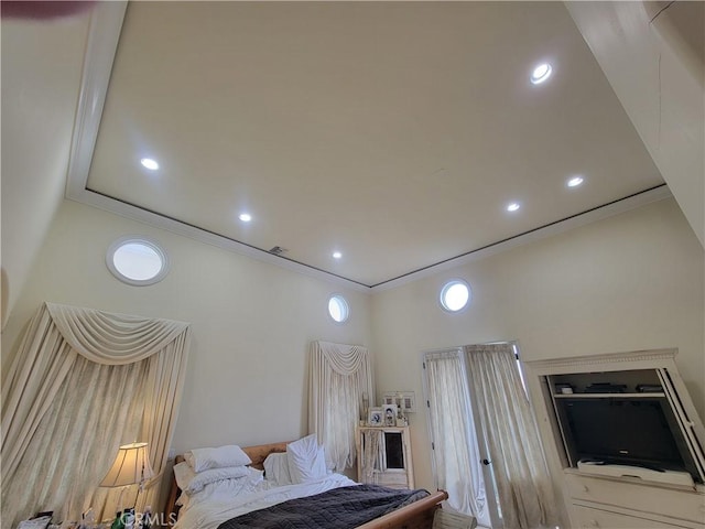 bedroom featuring ornamental molding, a high ceiling, and recessed lighting
