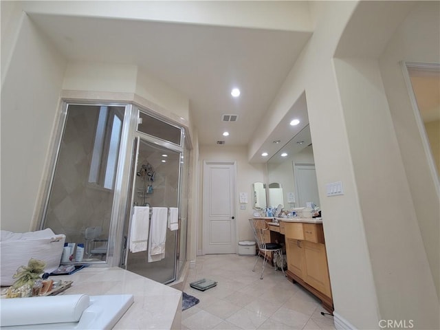 bathroom with vanity and a shower with door