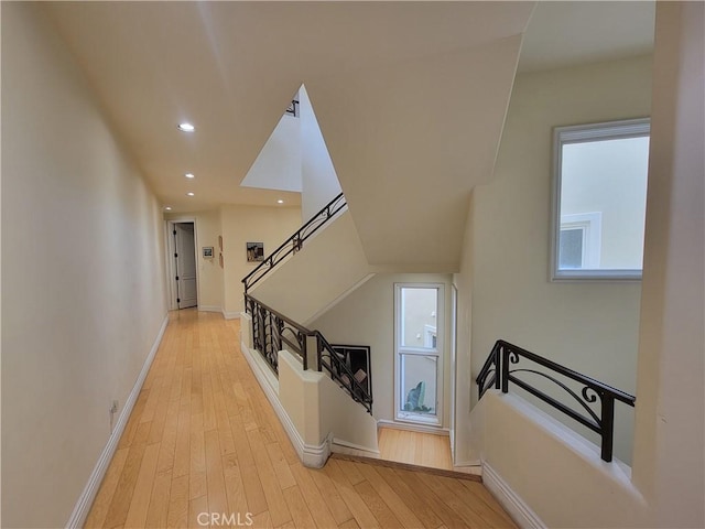 stairs with wood-type flooring and plenty of natural light