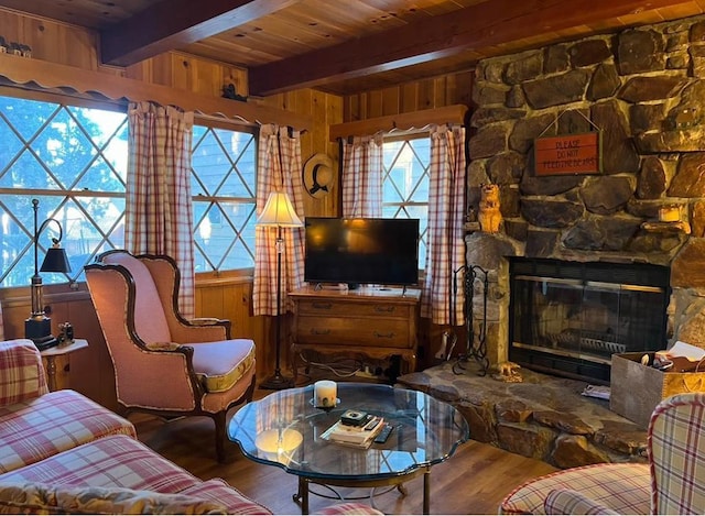 living room featuring wooden ceiling, wood-type flooring, a fireplace, and wood walls