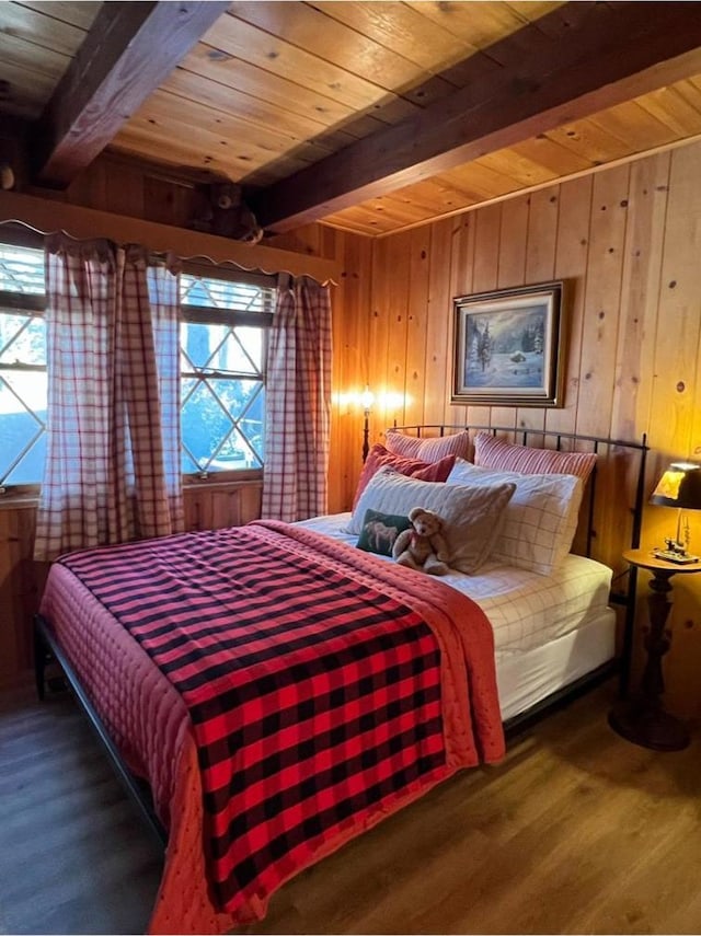 bedroom featuring wooden walls, wooden ceiling, dark hardwood / wood-style floors, and beamed ceiling