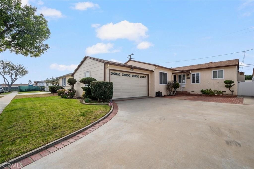 ranch-style house with a garage and a front yard