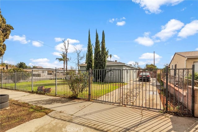 view of gate featuring a yard