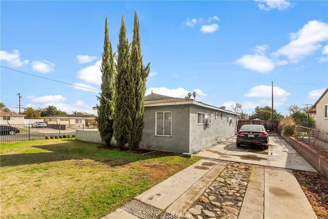 view of side of property with a lawn