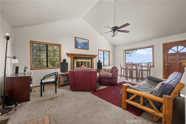 living room featuring a tiled fireplace, high vaulted ceiling, light carpet, and ceiling fan