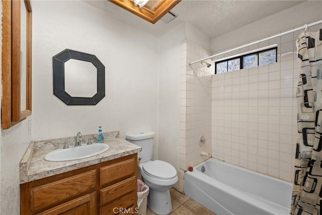 full bathroom featuring tile patterned floors, vanity, toilet, and shower / bath combo