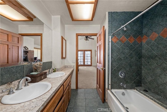 bathroom featuring a fireplace, tiled shower / bath combo, vanity, tile patterned floors, and french doors