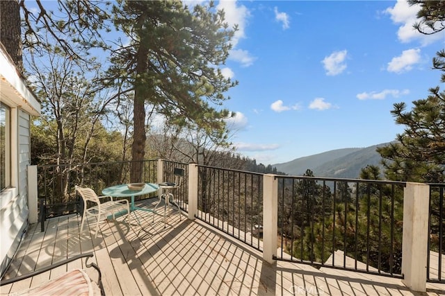 wooden deck featuring a mountain view