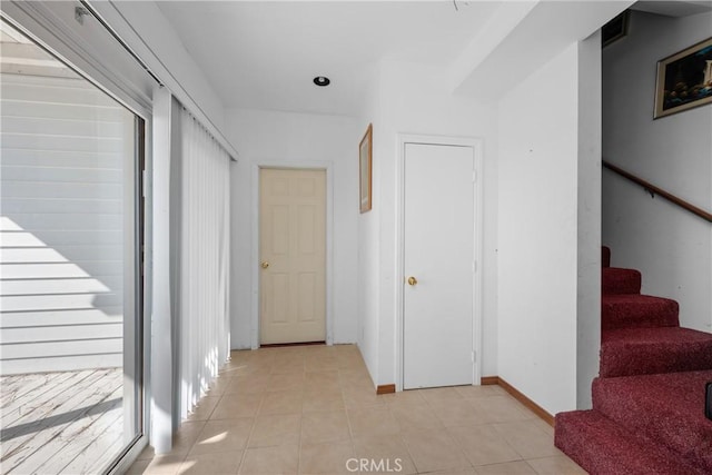 hall featuring light tile patterned flooring