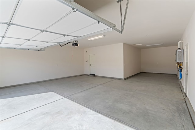 garage with a garage door opener and water heater