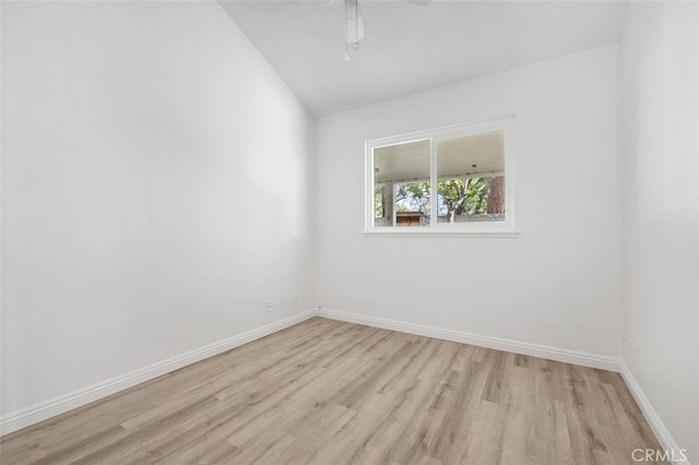 unfurnished room with ceiling fan, lofted ceiling, and light hardwood / wood-style flooring