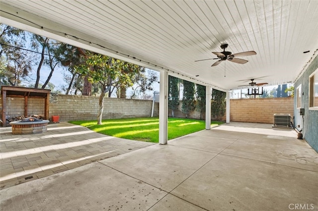 view of patio / terrace featuring central AC, ceiling fan, and an outdoor fire pit