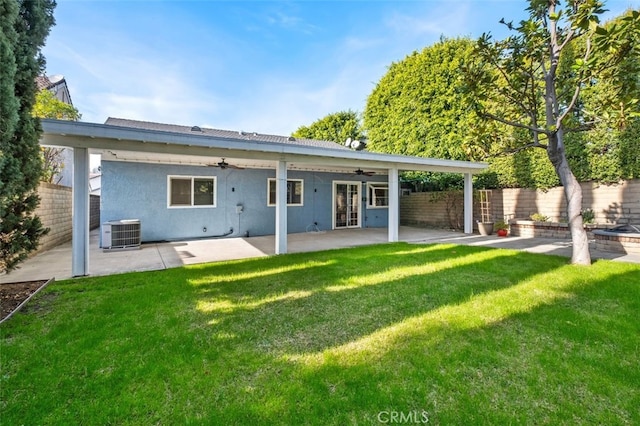 back of property with ceiling fan, a lawn, a patio, and central air condition unit